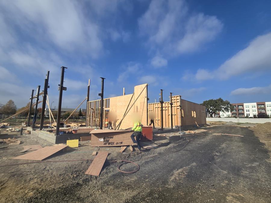 Structural steel and wood-frame walls going up