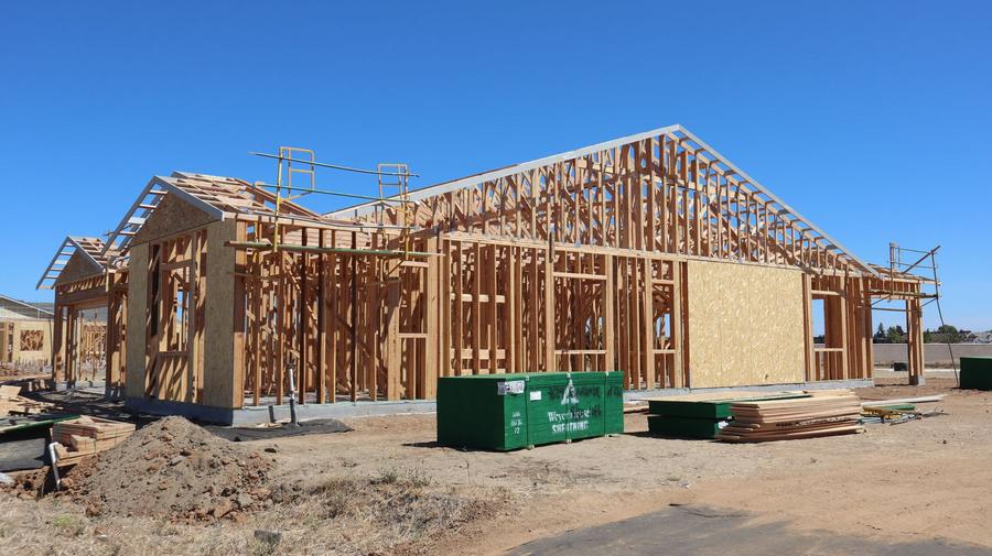 Wood framing under a blue sky
