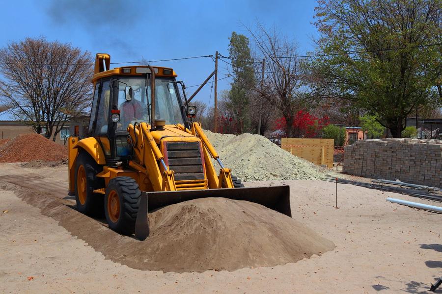 Site preparation with a backhoe loader